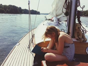 Girl reading on yacht