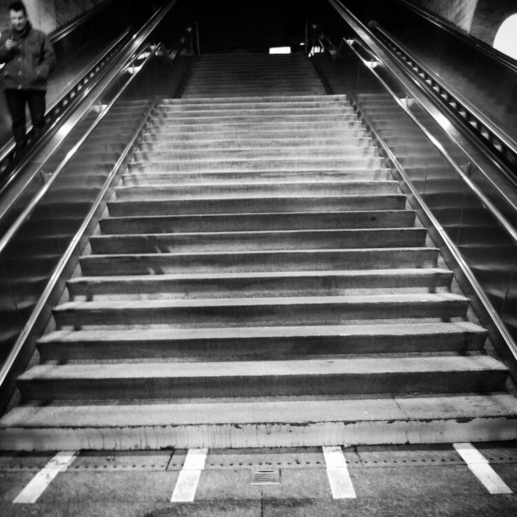 steps and staircases, steps, the way forward, staircase, high angle view, transportation, escalator, railing, diminishing perspective, indoors, incidental people, vanishing point, men, walking, on the move, moving up, travel, person, in a row