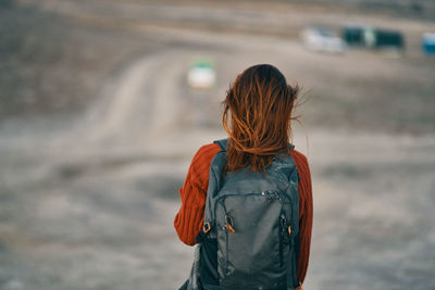 Rear view of woman standing outdoors