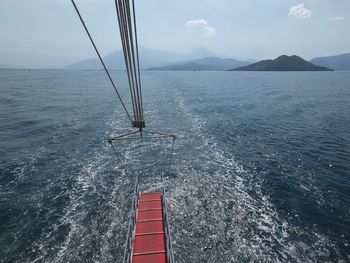 Sailboat sailing on sea against sky