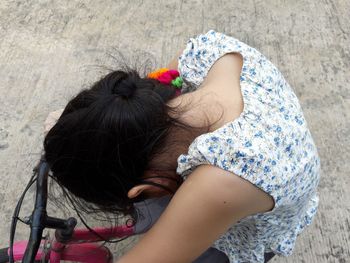 High angle view of girl sitting on floor