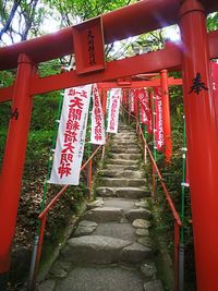 Red wooden gate hanging on steps