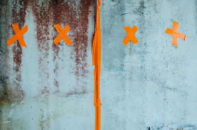 Close-up of wall with orange tape