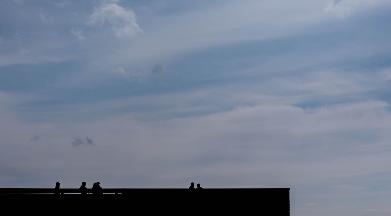 sky, cloud - sky, silhouette, nature, architecture, leisure activity, men, real people, outdoors, lifestyles, built structure, beauty in nature, group of people, low angle view, people, standing, scenics - nature, day, women, unrecognizable person