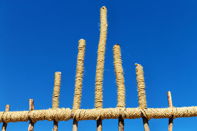 Low angle view of rope against blue sky