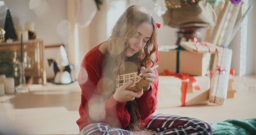 Side view of young woman using mobile phone