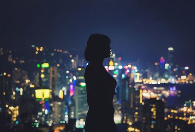 Side view of illuminated lighting against sky at night