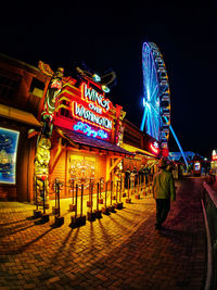 Low angle view of illuminated ferris wheel at night