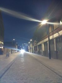 Illuminated street lights in city at night