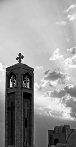 Low angle view of clock tower and building against sky