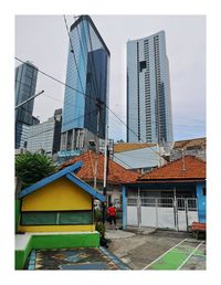 Modern buildings in city against sky