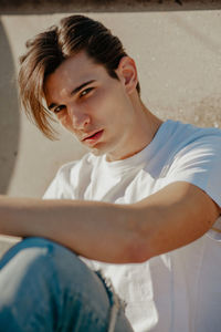 Portrait of young man sitting outdoors