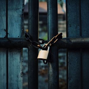 Close-up of padlock on metal fence