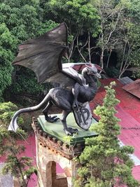 View of bird sculpture against plants