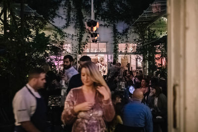 Group of people standing by tree in city