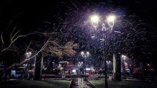 Low angle view of illuminated street light at night