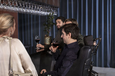 Group of friends having wine in bar