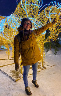 Full length portrait of smiling standing in snow