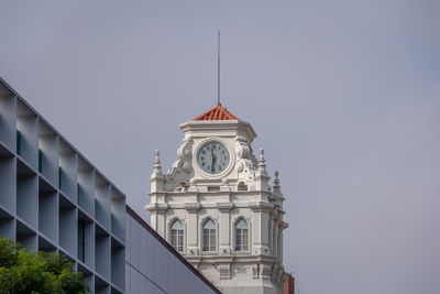 Low angle view of clock tower against clear sky