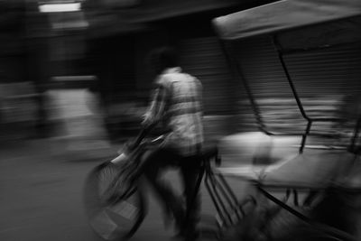 Blurred motion of man riding bicycle