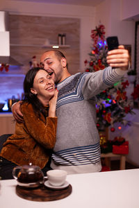 Midsection of man with woman sitting on table