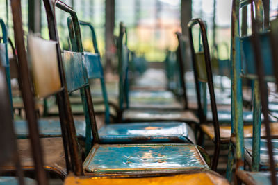 Empty metallic chairs in row at school