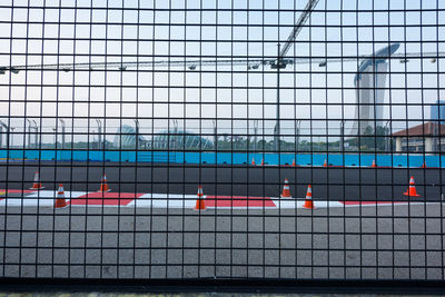 Reflection of fence on glass in city