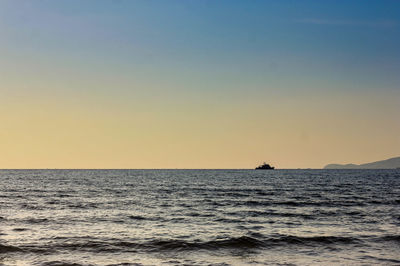 Scenic view of sea against clear sky during sunset