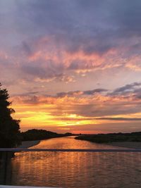 Scenic view of lake against orange sky