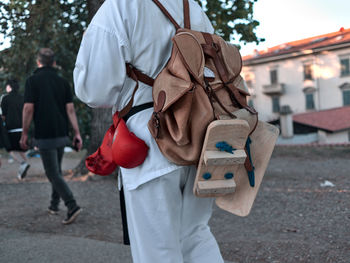 Low section of man standing on street