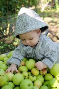 Close-up of baby girls on fruits