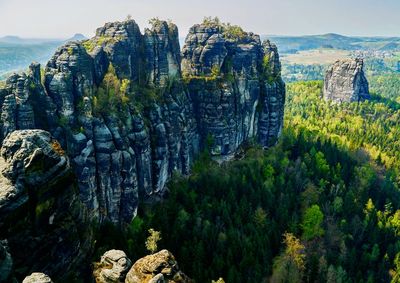 Panoramic view of rocks and trees against sky