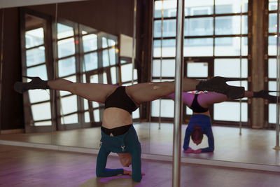 Rear view of woman exercising in gym