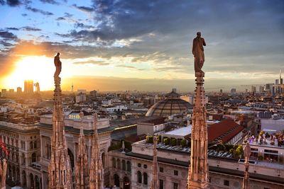 Panoramic view of city buildings against sky during sunset