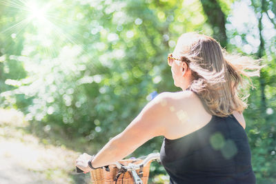 Woman standing by tree