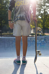 Portrait of young woman exercising on road