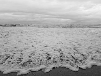 Scenic view of sea against storm clouds