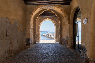 View to the old harbour and beach from porta pescara fishermen's gate in cefalu, sicily