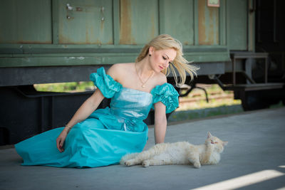 Portrait of young woman with cat