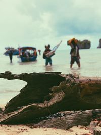 People on beach against sky