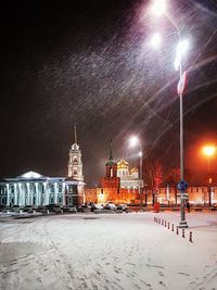 Illuminated street lights in city at night