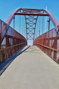 Empty footbridge against clear sky