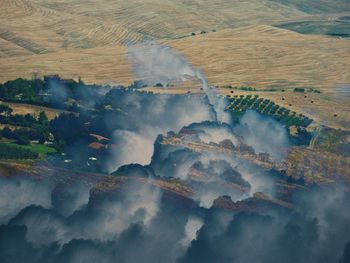 Double exposure angle view of tuscany land through the clouds