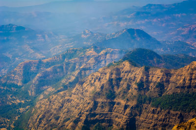 High angle view of land and mountains against sky