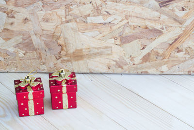 High angle view of red gift boxes on wooden table