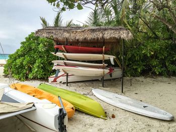 Boat moored on beach against sky