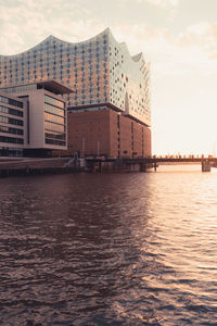 View of building by sea against sky