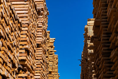 Low angle view of buildings against blue sky