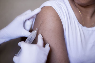 Woman receiving injection in her arm