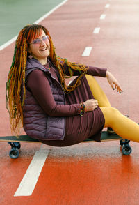 Portrait of young woman sitting on floor